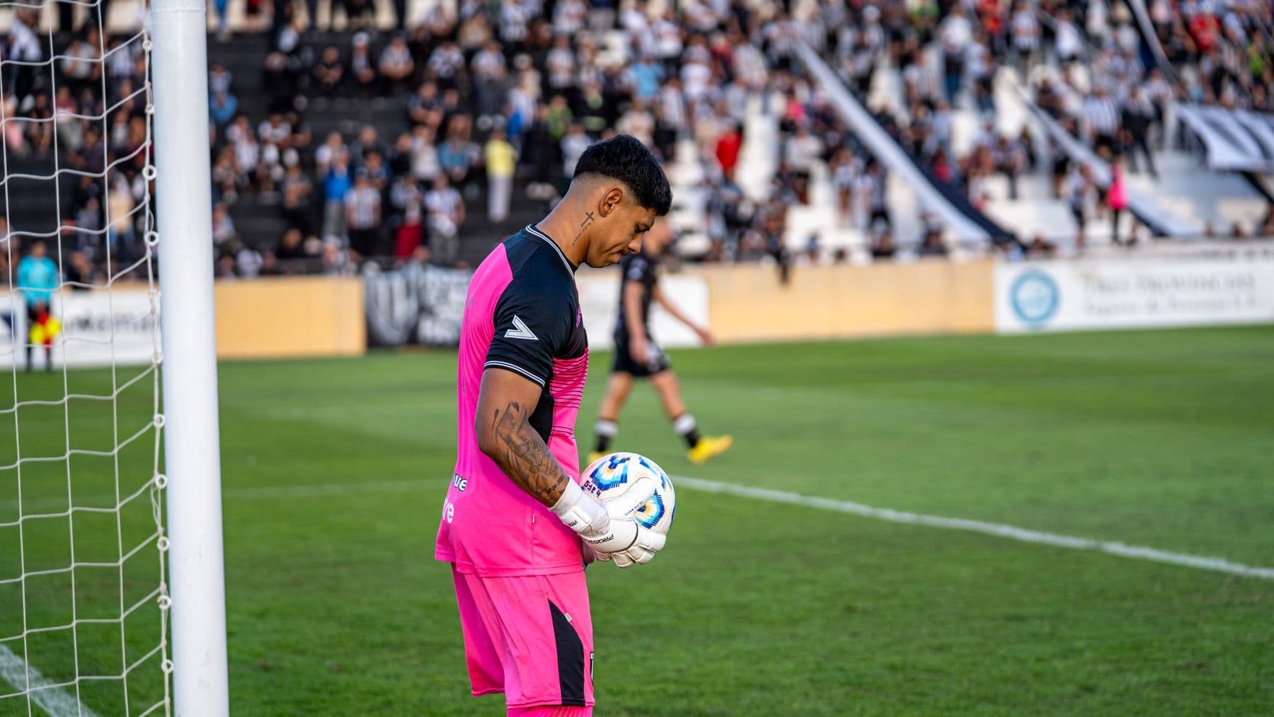Goalkeeper preparing to defend during a stadium match