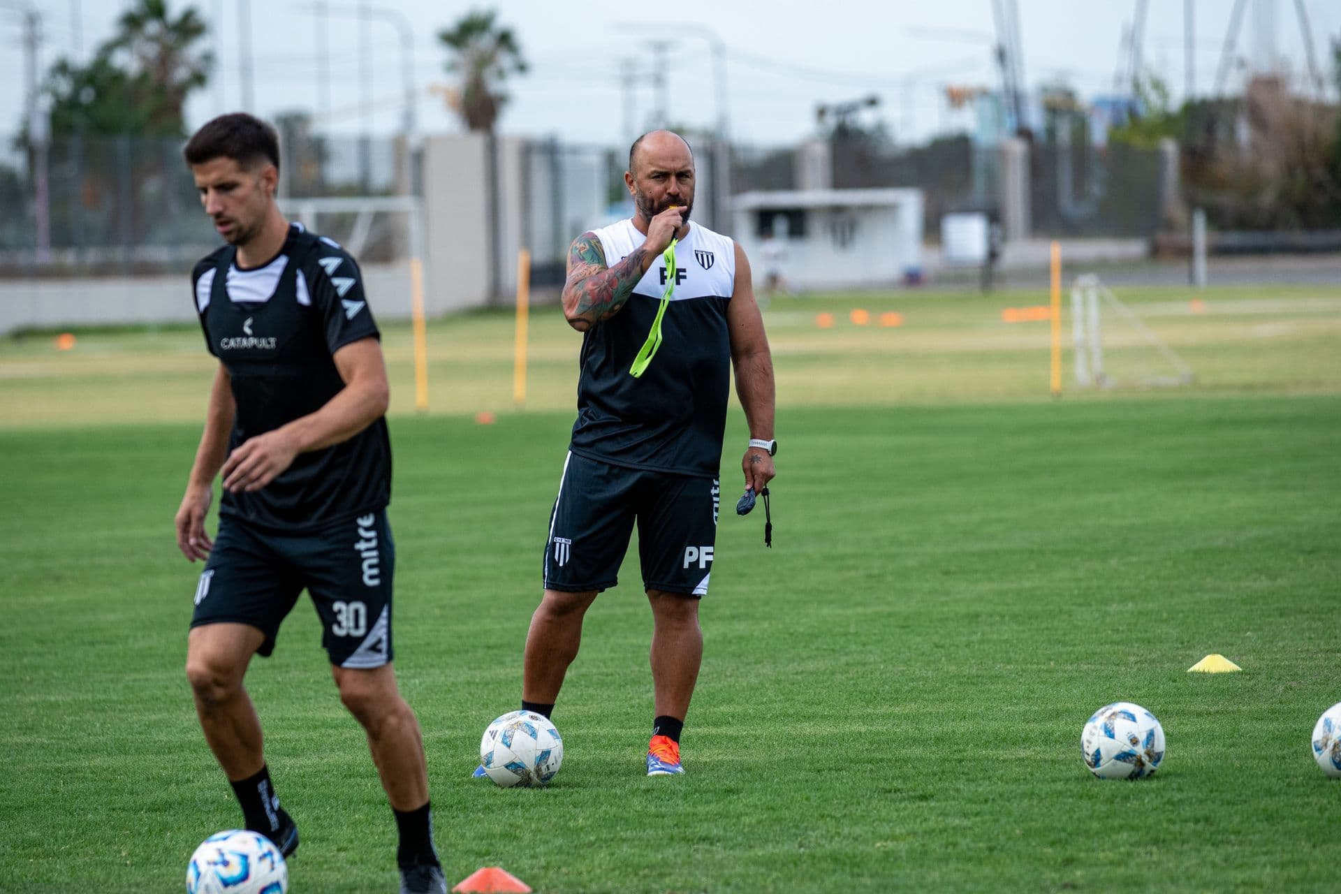 Coach directing a football training session