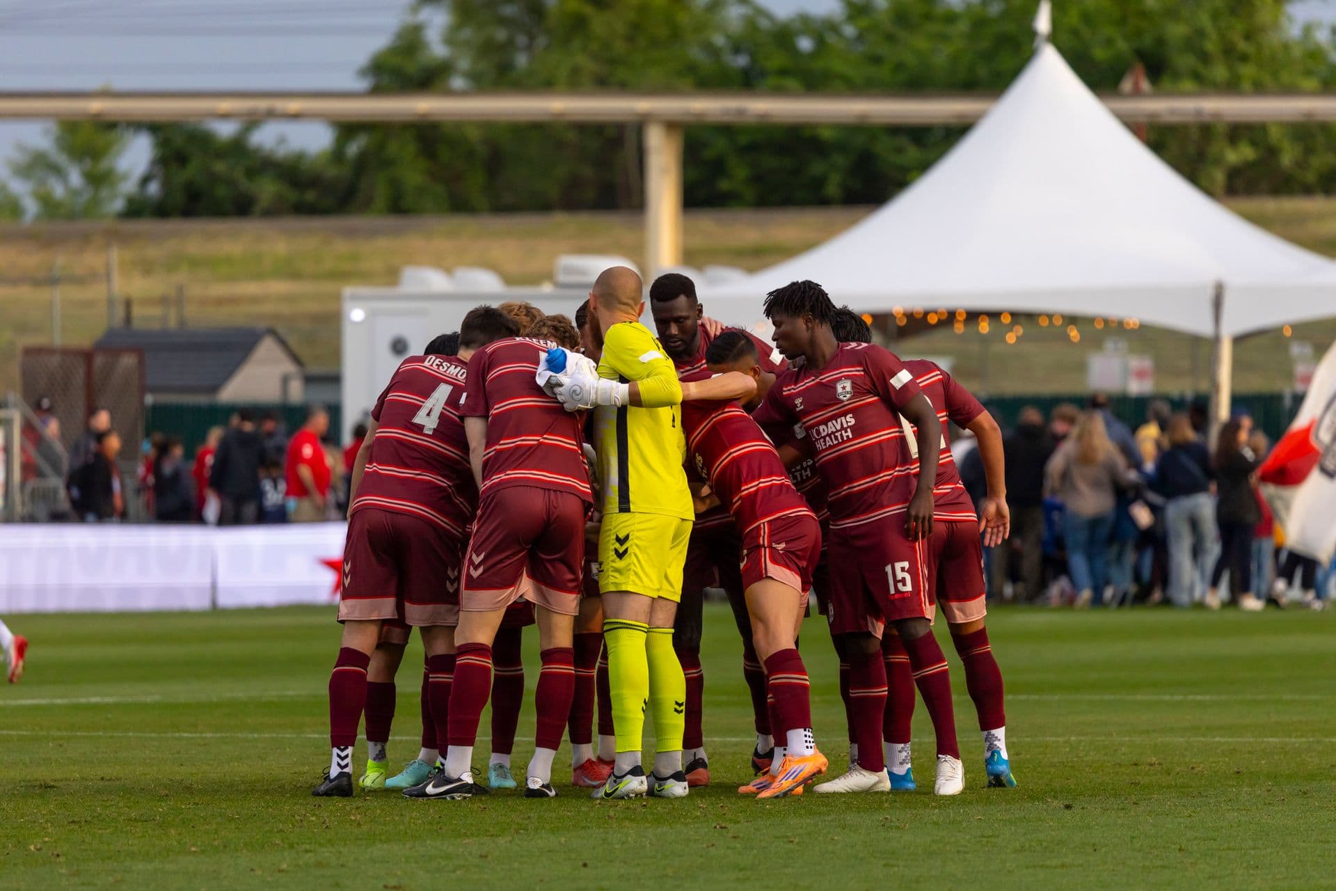 Football team gathering in a pre-match huddle