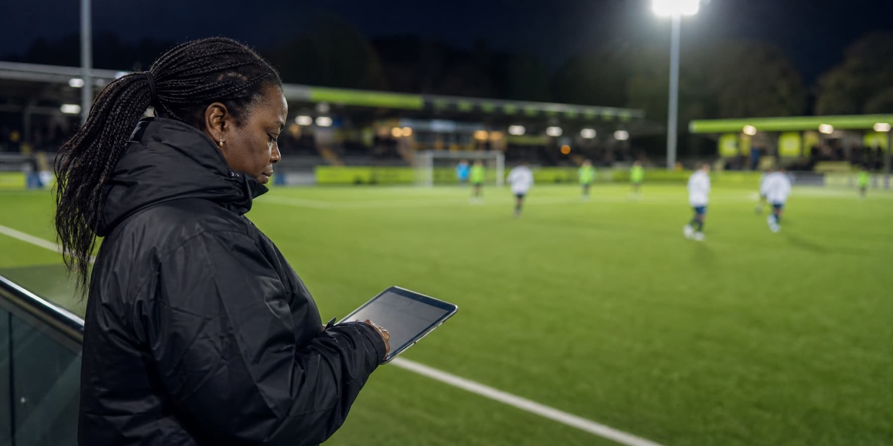 Football scout reviewing a match from the touchline